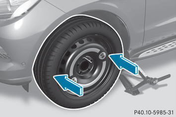– Slide the emergency spare wheel onto the